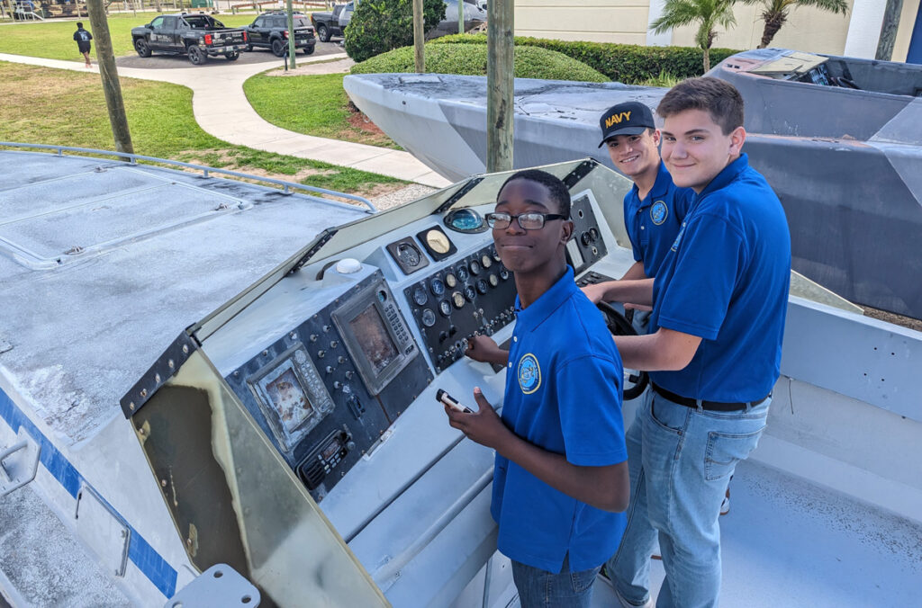 From left: Cadets Beaucejour, Rosario, and Franklin get hands-on with a Navy SEAL delivery boat