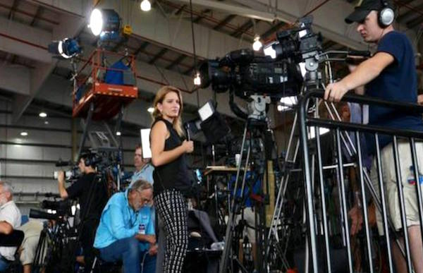 Most reporters were standing on chairs to cover the Trump rally. 