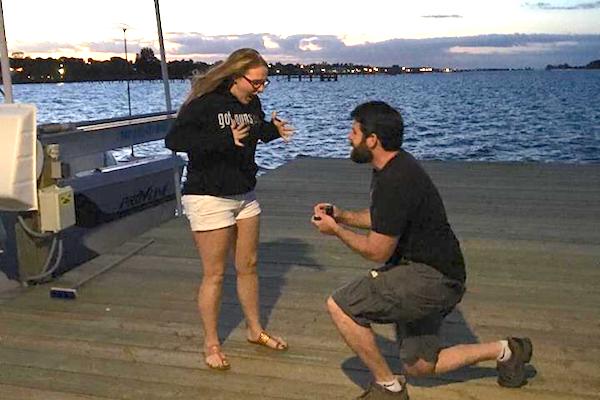 Arch McQuade asks Katie McGlaughlin for her hand in marriage on the pier at the Sebastian Tiki Bar & Grill.
