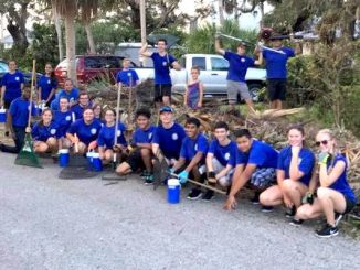 Sebastian River High School band members help clean up neighborhood.