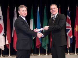 Major Eric Flower, on right in photo, graduates from the FBI Academy.