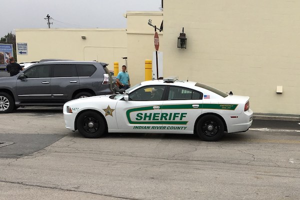 Investigators seen here loading vehicles with documents and other materials fbehind a massage parlor in Roseland.