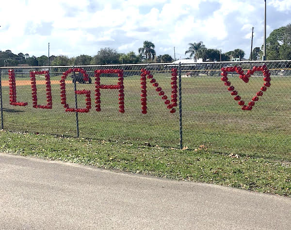 Julie Sharkey-Villars spells out Logan's name at ball park on Barber Street.