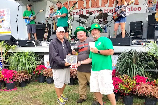Tiki Bar & Grill (owner John Campbell on right) wins Golden Shrimp Award at ShrimpFest in Sebastian, Florida.