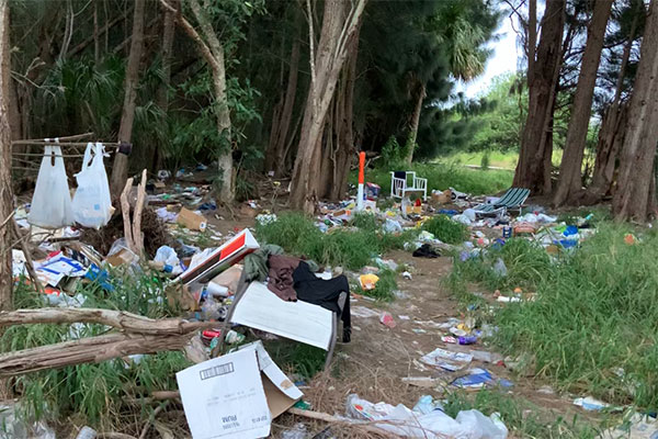 Trash left by two homeless men near the entrance to Barefoot Bay.