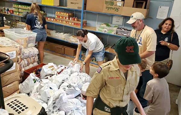Boy Scouts help in fight against hunger during food drive in Sebastian, Florida.