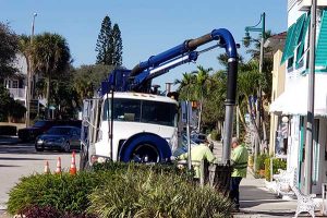 Vero Beach city workers clear drains clogged with confetti by Grind & Grape.