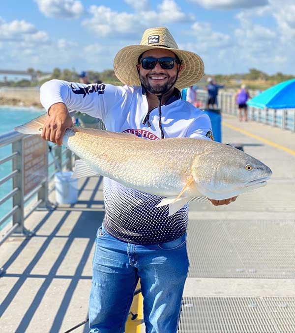 Nuno Ventura caught a red fish at Sebastian Inlet.