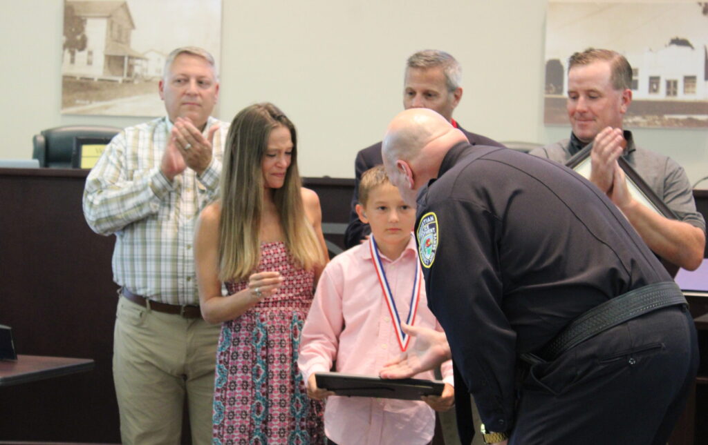 Chief Dan Acosta presents Hero Award to Gage Kepley