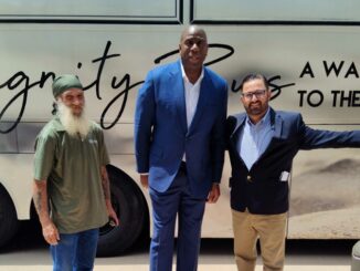 Standing in front of the Indian River County Dignity Bus, (left to right) Bus Driver Kyle, Magic Johnson and Anthony Zorbaugh. When touring the bus Johnson shared how great the Bus was and wished there were some in Los Angeles.