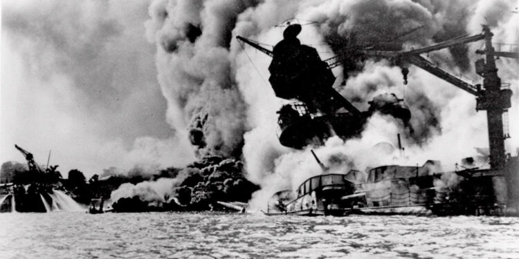 The infamous Japanese attack on Pearl Harbor, Hawaii, is shown in this Dec. 7, 1941 file photo. The USS Arizona is pictured in flames after being hit. (Credit: AP)