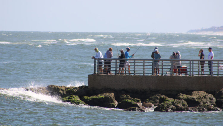 Anglers fishing on the South Jetty of the Sebastian Inlet.