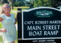 Scarlett Chesser in front of the Capt. Robert Hardee Main Street Ramp sign, marking a notable spot in the city