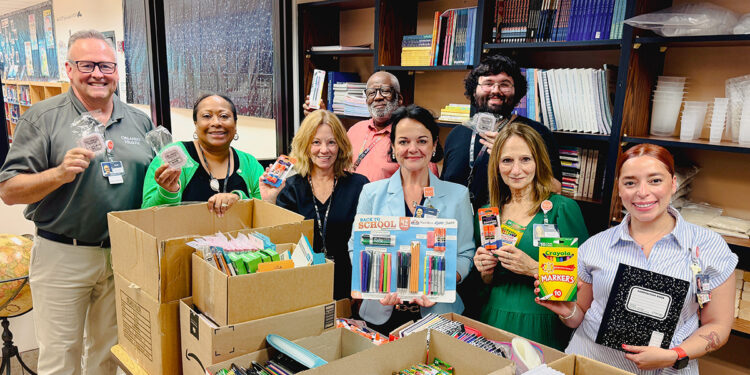 Team members from Orlando Health Sebastian River Hospital and staff from Sebastian Elementary celebrate the donation of 350 wired earbuds, additional school supplies and one year’s worth of medical supplies for the school clinic.