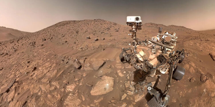 NASA’s Perseverance rover captured this selfie, stitched together from 62 individual images, on July 23, 2024, in Mars’ Jezero Crater. The arrowhead-shaped rock nicknamed “Cheyava Falls,” visible to the left of the rover near the image’s center, contains chemical features that could indicate ancient microscopic life on the Red Planet, though further study is needed.