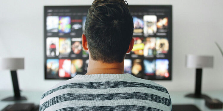 Americans increasingly stream new movies at home over theaters, highlighting post-pandemic viewing shifts. (Photo by Mohamed Hassan)