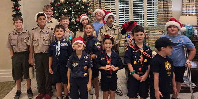 Cub Scouts from Pack 589 spread holiday cheer Thursday at Pelican Landing Assisted Living Facility in Sebastian.