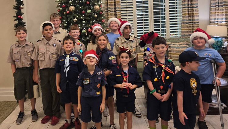 Cub Scouts from Pack 589 spread holiday cheer Thursday at Pelican Landing Assisted Living Facility in Sebastian.