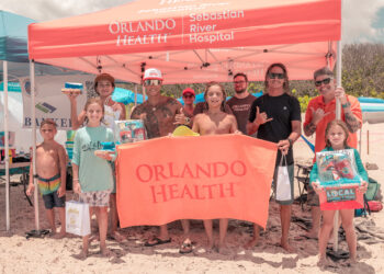 Orlando Health volunteers and members of Sober Surfers engaged with community members at the Orlando Health tent during the Longest Day, Longest Ride Surf Contest at Sebastian Inlet, hosted by the Sebastian Chamber of Commerce and held at Sebastian Inlet on Sunday, June 21. Orlando Health sponsored nine Sober Surfers participants in the contest, where surfer Brad Lee (pictured, fourth from left) won first place. Orlando Health team member Victor Rodriguez served as a judge, while additional team members distributed sunscreen and beach balls and raffled off a boombox and beach chairs. The family-friendly event raised funds and awareness for Alzheimer’s disease.