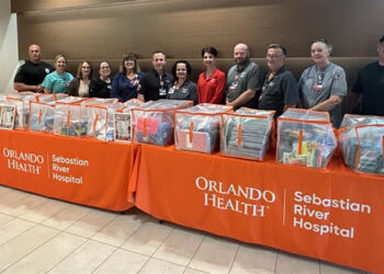 Hospital staff and Sebastian police officers sort and prepare 3,558 donated school supplies for local K-8 students
