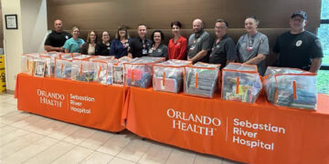 Hospital staff and Sebastian police officers sort and prepare 3,558 donated school supplies for local K-8 students